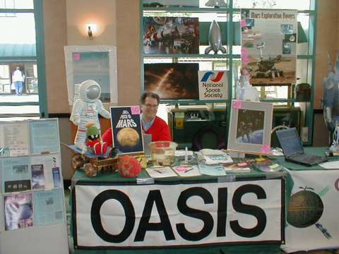 Bob Gounley behind the OASIS fan table at LOSCON 30 in Burbank
