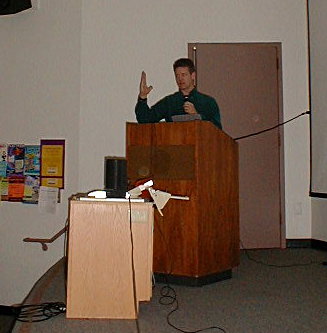 Rex Ridenoure speaking a Calstate Long Beach