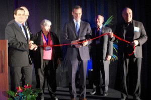 Los Angeles Mayor Eric Garcetti (center) cuts the ribbon opening ISDC 2014 as (from left) co-chair Nicola Sarzi-Amade, MC Ivan Rosenberg, chair Pat Montoure, keynote speaker David Gorney, and co-chair John Spencer look on. (Photo: Michael McGuire)