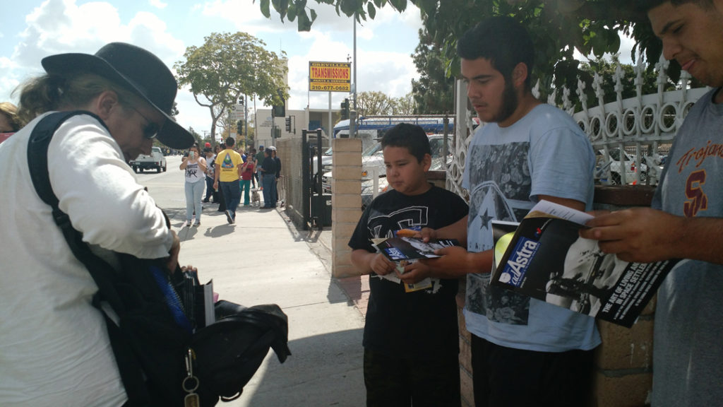 Gareth Powell distributes Ad Astra magazines and 3D-printed space shuttles to the people watching the space shuttle external tank heading to the California Science Center.