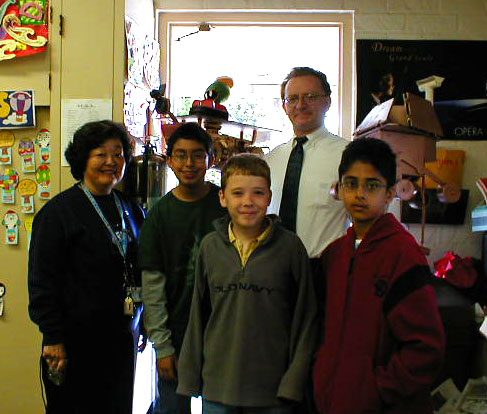 Photograph of the winners of the art contest with their teacher.